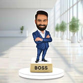 Boss Caricature - Custom Gift | Desk Addition, Farewell Gift featuring a smiling man in a blue suit with folded arms on a white base labeled 'BOSS'.